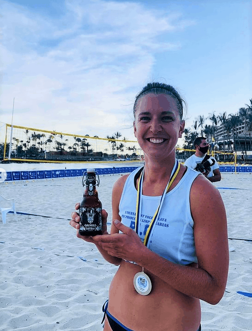 Dr Sarah Wetttsadt at the beach and with medals from beachvolleyball